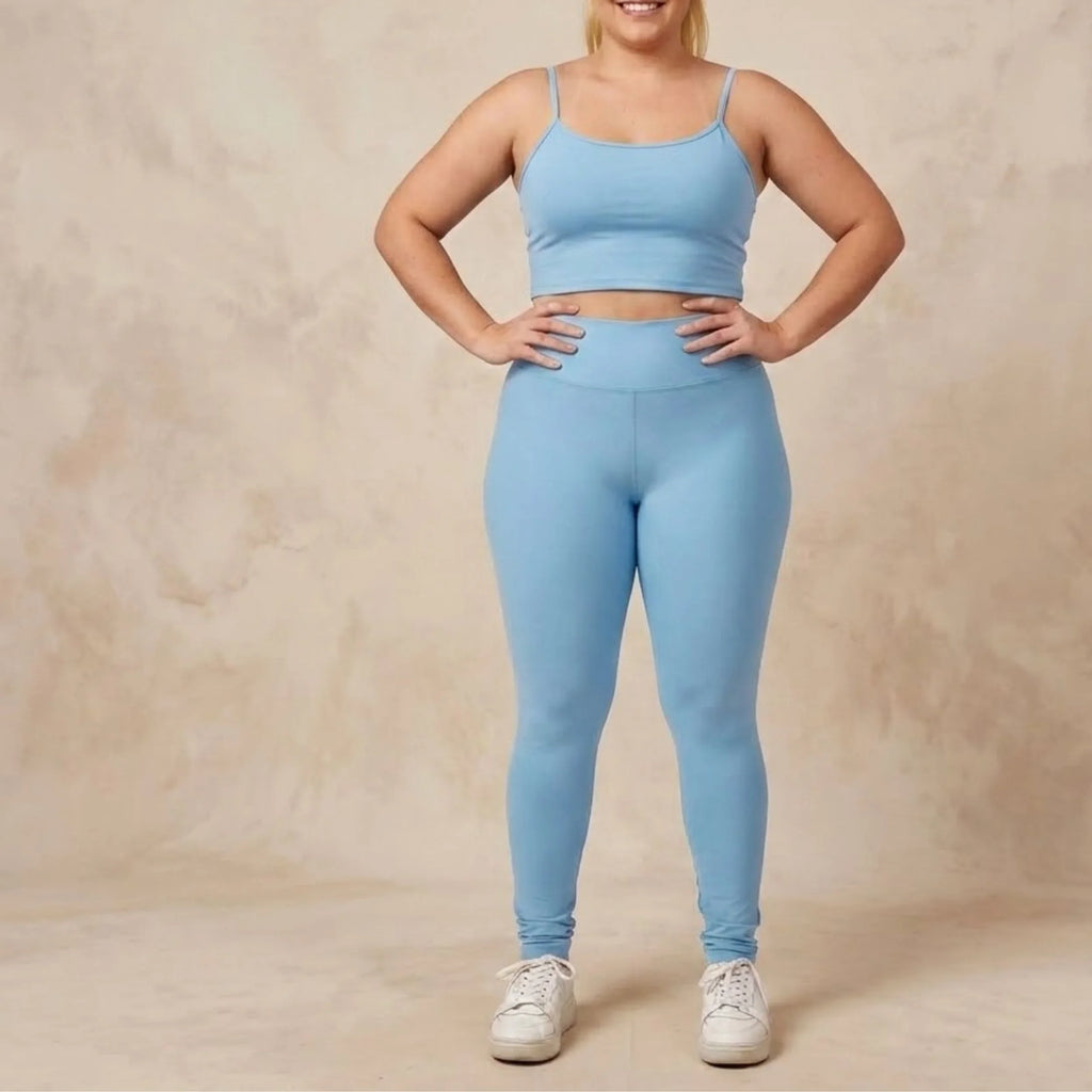 Modelo usando calça legging premium suplex azul claro e top combinando.